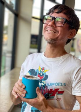 Chris Mitchell holding a cup